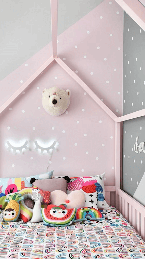 quarto de criança com cama rosa e papel de parede de bolinhas brancas