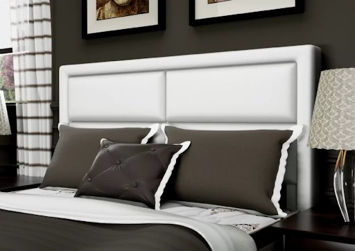 uma cama com cabeceira branca e duas fotos emolduradas acima dela